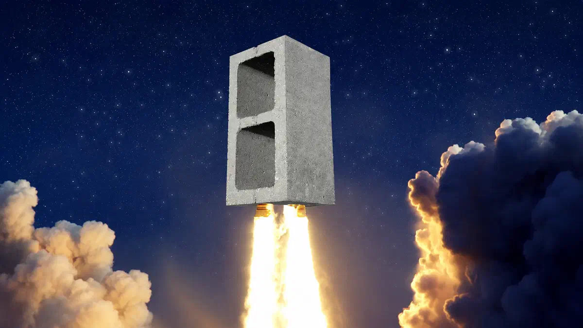 A concrete cinder block launching like a rocket through a starry night sky, with bright exhaust flames and dramatic clouds illuminated below.